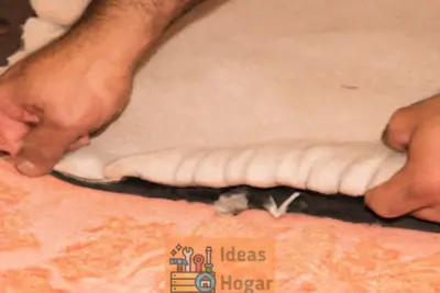 Manos de un profesional reparando una alfombra